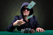 Photo: Poker player throwing two ace cards on black background Poker player throwing two ace cards on black background