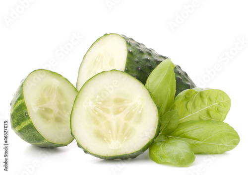 Photo: Sliced cucumber vegetable and basil leaves still life Sliced cucumber vegetable and basil leaves still life