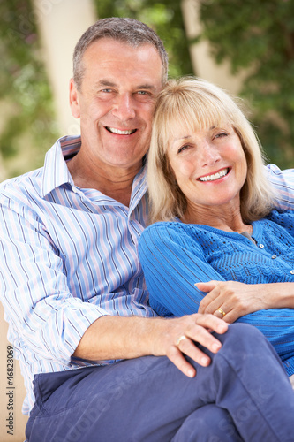 Photo: Senior Couple Relaxing On Sofa At Home Senior Couple Relaxing On Sofa At Home