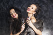 Joy. Elation. Rich woman laughing with crystal of champagne