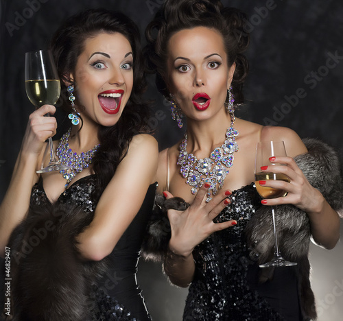 Photo: Couple of women celebrating birthday in restaurant. Holidays Couple of women celebrating birthday in restaurant. Holidays
