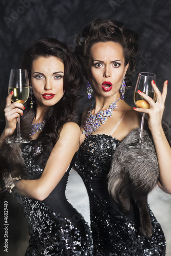 Photo: Fashion women drinking champagne in nightclub. Merry Christmas! Fashion women drinking champagne in nightclub. Merry Christmas!
