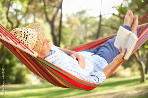 Photo: Senior Man Relaxing In Hammock With Book Senior Man Relaxing In Hammock With Book