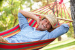 Man Relaxing In Hammock