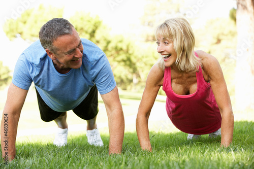Photo: Senior Couple Exercising In Park Senior Couple Exercising In Park