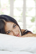 Photo: Portrait of young beautiful woman on white sheet Portrait of young beautiful woman on white sheet