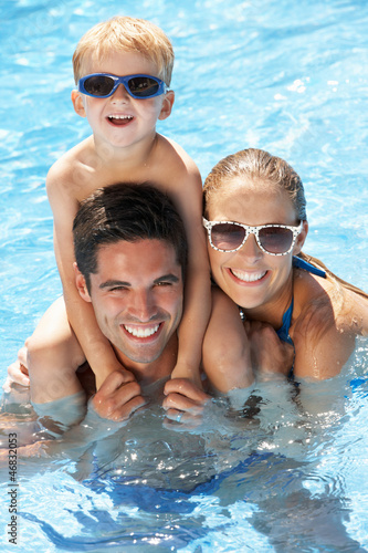 Photo: Family Having Fun In Swimming Pool Family Having Fun In Swimming Pool