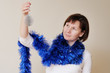 Woman holding silvery christmas toy