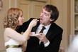 Bride and groom are eating their wedding cake