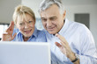 Senior couple connected with family on internet