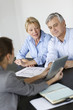 Senior couple meeting architect for building project