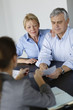 Senior couple signing financial contract
