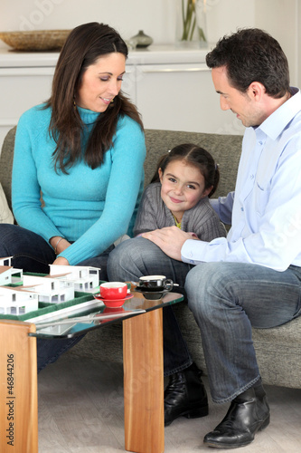 Photo: Family looking at a new-build model Family looking at a new-build model