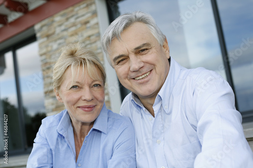 Photo: Cheerful senior couple looking at camera Cheerful senior couple looking at camera
