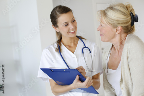 Photo: Nurse giving presciption to elderly woman Nurse giving presciption to elderly woman