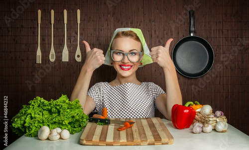 Photo: Woman cook with okay sign cut carrot-vintage concept Woman cook with okay sign cut carrot-vintage concept