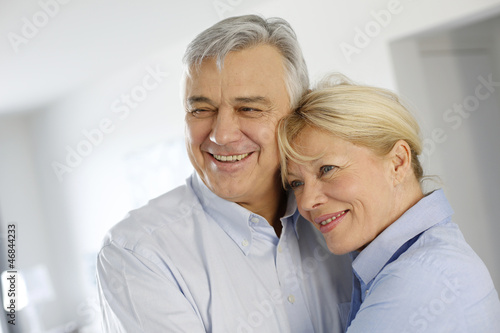 Photo: Portrait of cheerful senior couple at home Portrait of cheerful senior couple at home