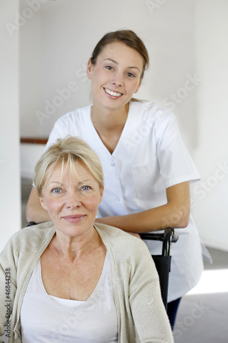 Photo: Nurse at home with elderly person in wheelchair Nurse at home with elderly person in wheelchair