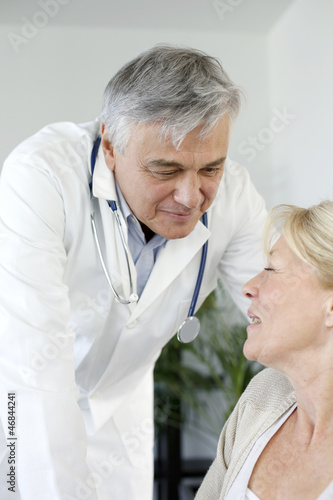 Photo: Portrait of surgeaon talking to patient in wheelchair Portrait of surgeaon talking to patient in wheelchair