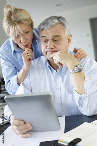 Photo: Senior couple trying to figure out tax declaration Senior couple trying to figure out tax declaration
