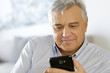 Portrait of senior man using smartphone