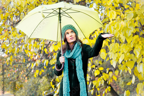 Photo: beautiful young girl under yellow umbrella beautiful young girl under yellow umbrella