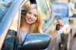 Photo: Young woman showing car key Young woman showing car key