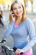 Woman on bike with mobile phone