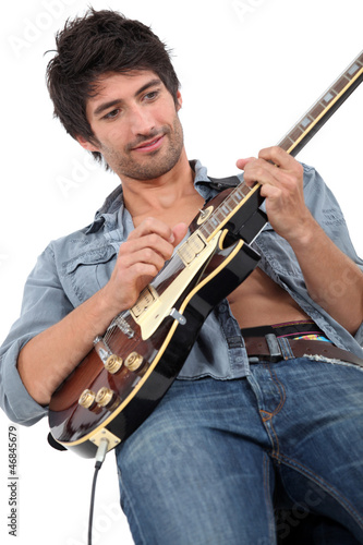 Photo: young man playing guitar young man playing guitar