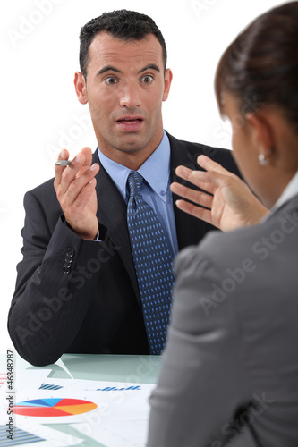 Photo: businessman and businesswoman having a discussion businessman and businesswoman having a discussion