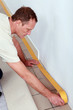 Man at home preparing to lay new flooring