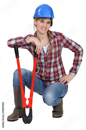 Photo: Craftswoman holding a huge spanner Craftswoman holding a huge spanner