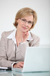 Woman in glasses at laptop computer