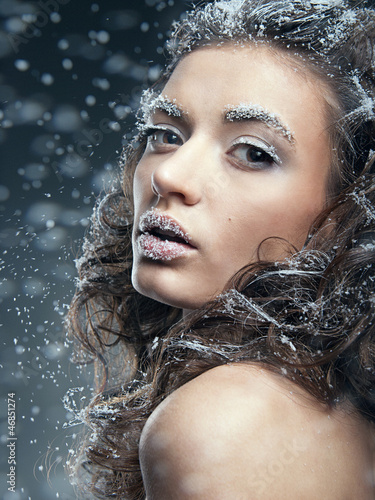 Photo: Portrait of young woman with snow make-up. Christmas snow queen Portrait of young woman with snow make-up. Christmas snow queen