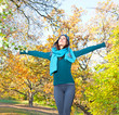 Happy young pretty woman at the autumn park.