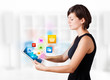 Young woman looking at modern tablet with colourful icons