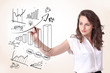 Young business woman drawing diagrams on whiteboard