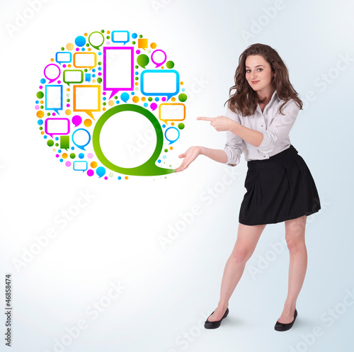 Photo: Young business woman presenting colourful speach bubble Young business woman presenting colourful speach bubble