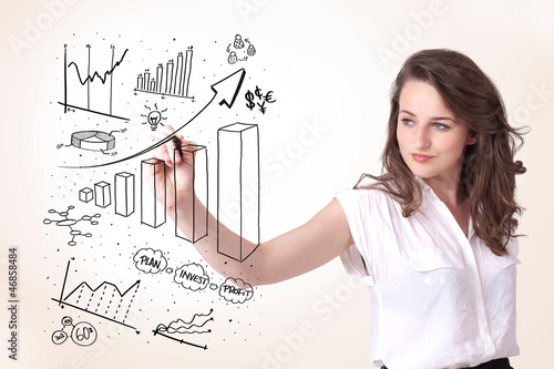 Photo: Young business woman drawing diagrams on whiteboard Young business woman drawing diagrams on whiteboard