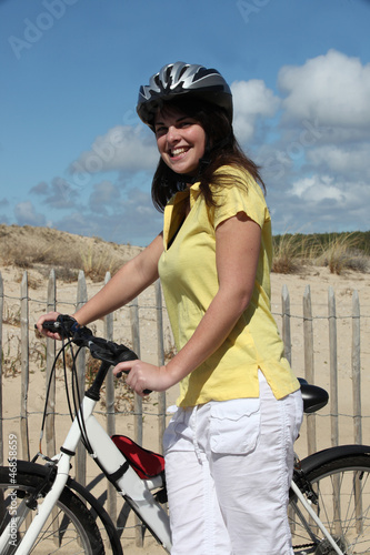 Photo: Woman taking a bike ride at the beach Woman taking a bike ride at the beach