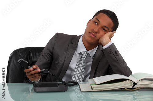 Photo: Bored telephone sales worker Bored telephone sales worker