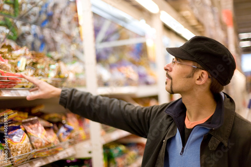 Photo: Man checking food labelling Man checking food labelling
