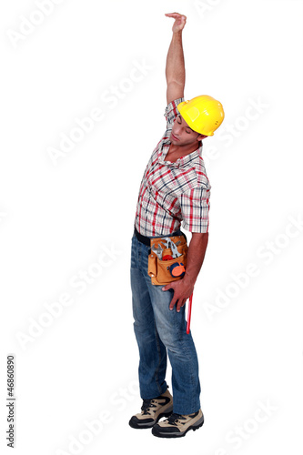 Photo: Construction worker hanging in empty space Construction worker hanging in empty space
