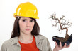 Woman holding burnt tree