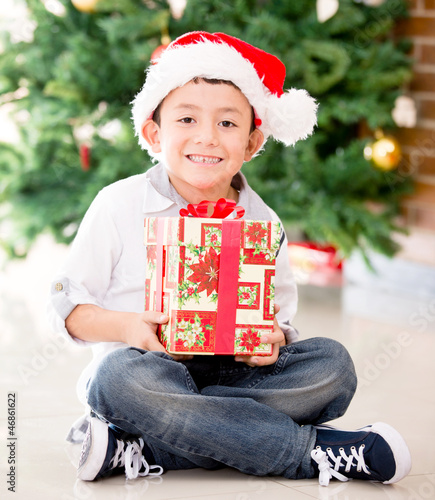 Photo: Happy boy with a Christmas gift Happy boy with a Christmas gift