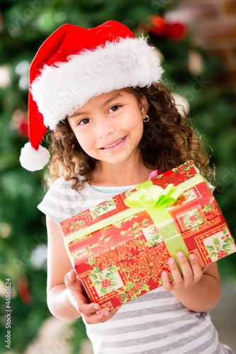 Photo: Christmas girl holding a present Christmas girl holding a present
