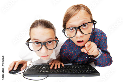 Photo: Young girls playing or working on a computer Young girls playing or working on a computer