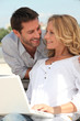 Man behind woman with computer