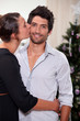 Couple kissing at Christmas