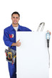 young electrician with panel making okay sign